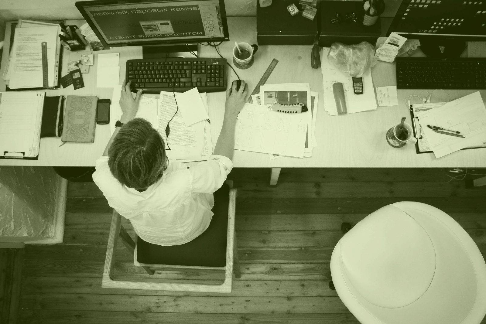 Overhead view of an office desk with documents and a laptop